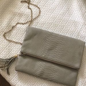 Grey foldover purse with chain.